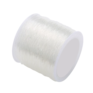 Single roll of clear elastic beading cord for DIY jewelry making on white background