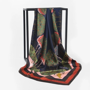 Detail view of large floral satin silk scarf with elegant fruit tree print on metal rack