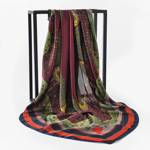 Detail showing vintage floral satin scarf draped on a black metal frame with soft lighting