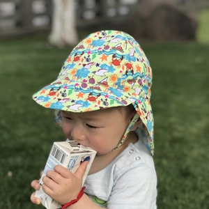 Close-up of baby sun hat with neck flap featuring colorful crab and sea print