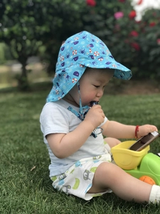 Detail of blue sun hat with sea life print and adjustable drawstring for kids outdoors
