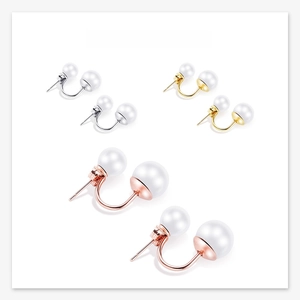 Detailed view of double pearl earrings in silver, gold, and rose gold finishes