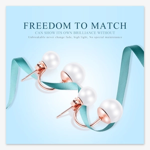 Detail of rose gold pearl earrings on a light blue background with a silk ribbon