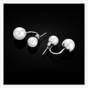 Macro detail of 10mm double pearl stud earrings with polished silver stainless steel base