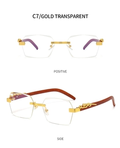 Detail of rimless sunglasses with leopard metal trim and red wood grain temples