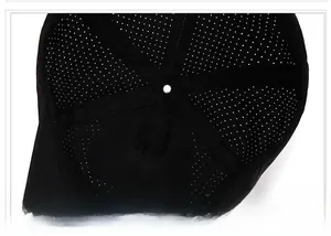 Detail view of breathable laser-cut holes and reinforced seams inside the black sports cap