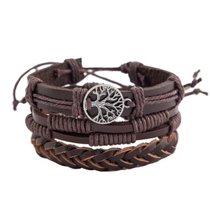 Detail of vintage multilayer brown leather bracelet featuring a silver tree of life charm