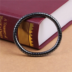 Detail of segmented black hematite beaded bracelet on a vintage book surface