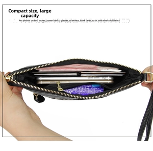 Internal view of minimalist leather envelope bag showing card slots and storage capacity