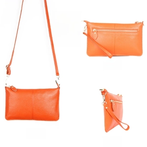 Detailed views of orange lychee grain leather envelope bag with adjustable crossbody strap