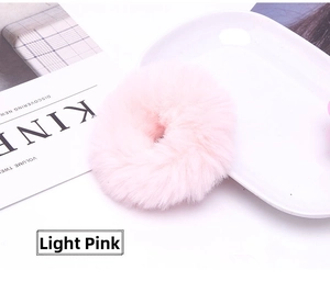 Detail shot of light pink faux rabbit fur hair scrunchie with soft fluffy texture