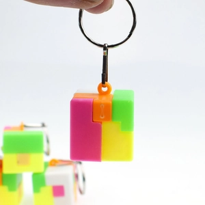 Detail of colorful puzzle block keychain showing modular plastic design with metal ring
