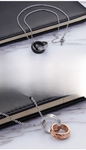Macro detail of interlocking rings with crystal inlay and engraved love inscription