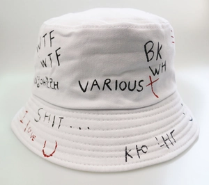Detail of white cotton bucket hat with black and red graffiti prints and street style text