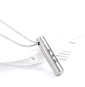 Macro detail of brushed stainless steel cylindrical urn pendant with DAD engraving