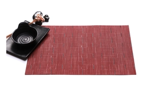Detail of red Teslin PVC placemat with bamboo weave texture on a minimalist table