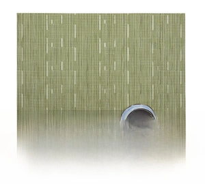 Detail view of a green woven PVC placemat with bamboo texture and ceramic teacup