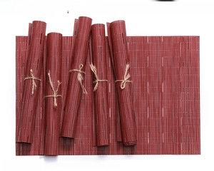 Macro detail of reddish brown woven PVC placemat showing heat resistant bamboo texture