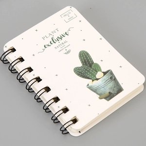 Detailed close-up of a spiral-bound A7 notebook with a cute cactus illustration and green text
