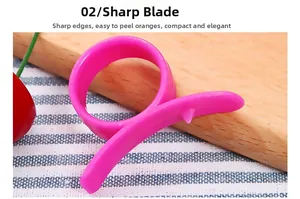 Detail view of sharp pink orange peeler blade and ring design for easy fruit peeling