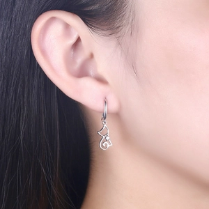 Elegant S925 sterling silver cat-shaped earrings with zircon heart detail on model