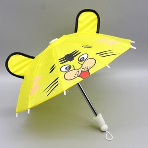 Detailed macro view of a yellow 18-inch doll umbrella featuring a cute cartoon tiger face