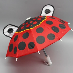 Close-up of a 18-inch doll umbrella featuring a red ladybug design with black spots