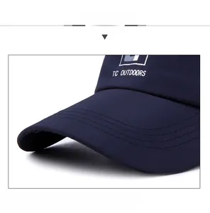 Close-up of navy baseball cap with white TC Outdoors embroidery and reinforced stitching