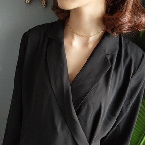 Close-up of a minimalist 925 sterling silver gold Figaro chain necklace on neck