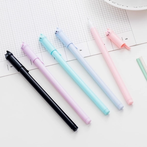 Set of five creative cat-shaped neutral pens in pastel colors on a white workspace
