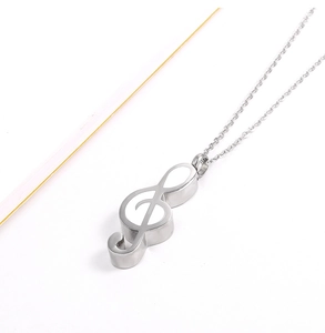 Detailed side view of silver treble clef musical note cremation urn pendant