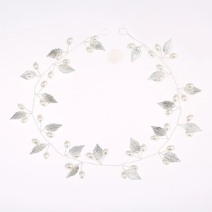Detail of silver leaf bridal headband with white pearls and hand-woven wire texture