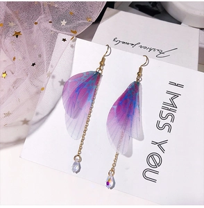 Detail of handmade butterfly wing earrings with purple gradient and crystal drop