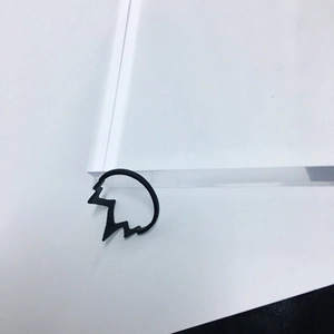 Close-up of a matte black lightning bolt ring with a unique zigzag ECG design