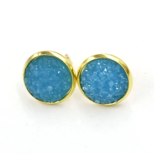 Close-up of 12mm gold-plated stud earrings with light blue druzy resin crystals