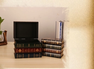 Set of three vintage decorative book storage boxes in red, green and blue with gold foil