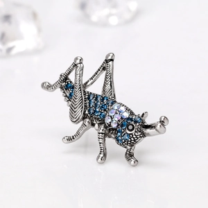 Retro insect grasshopper brooch with sparkling blue rhinestones and antique silver finish