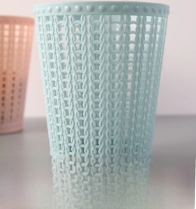 Detail of sky blue woven hollow plastic mini desktop bin with decorative dotted rim