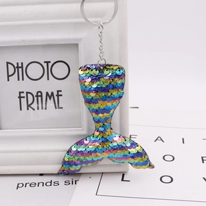 Detail of colorful gradient sequins on a mermaid tail keychain with silver metal ring