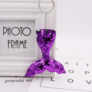 Close-up of sparkling purple sequin mermaid tail keychain with silver metal ring