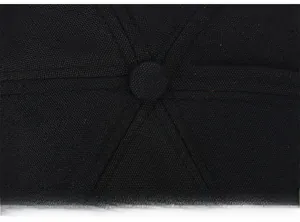 Close-up of black canvas baseball cap top showing detailed stitching and fabric texture