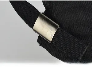 Detail of adjustable black strap with silver metal buckle on the canvas baseball cap