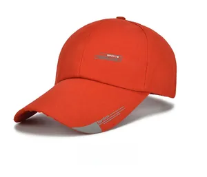 Close-up of red canvas baseball cap featuring sports fashion embroidery and curved brim