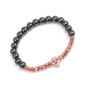 Détail du bracelet tête de mort avec yeux rouges et perles en hématite