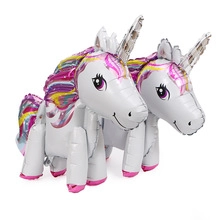 Detailed view of two unicorn foil balloons with rainbow mane and horn for party decoration