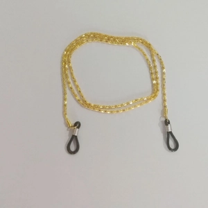 Close-up of golden metal eyeglass chain with black rubber adjusters on white background