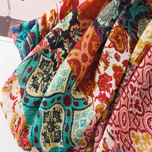 Detailed view of colorful ethnic floral print fabric with soft drape and paisley patterns