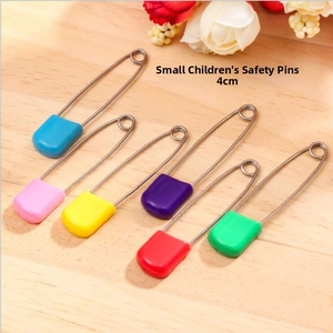 Close-up of 4cm colorful safety pins with plastic heads for baby clothes and knitting