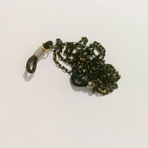 Detail of black non-slip glasses chain with rubber loops and metallic spiral accents
