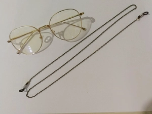 Detail of bronze metal anti-slip glasses chain with adjustable rubber connector loops